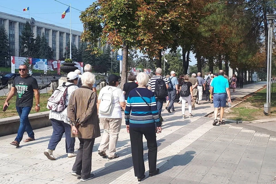 В центре Кишинева немецкие пенсионеры организованной группой шла за гидом в сторону Триумфальной арки
