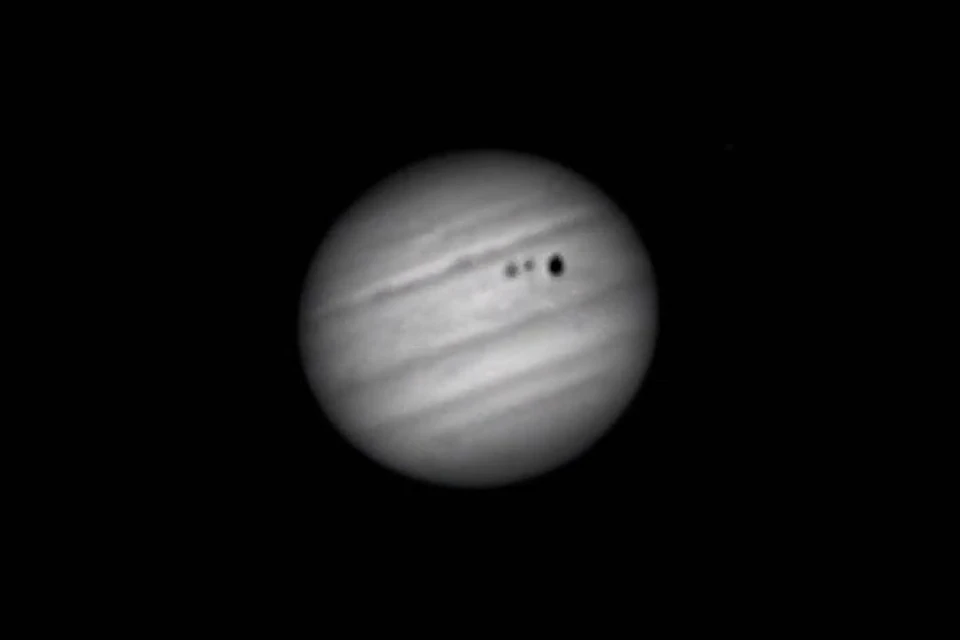 Два спутника — Ганимед и Европа — проходят перед самой большой планетой Солнечной системы — Юпитером. Фото: Кадр из видео\ Алексей Поляков